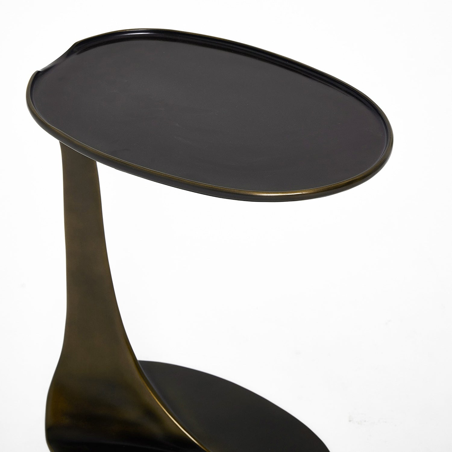 Detail of the sculptural frame on the Interlude Home Duval Deep Bronze Grand Hugging Table