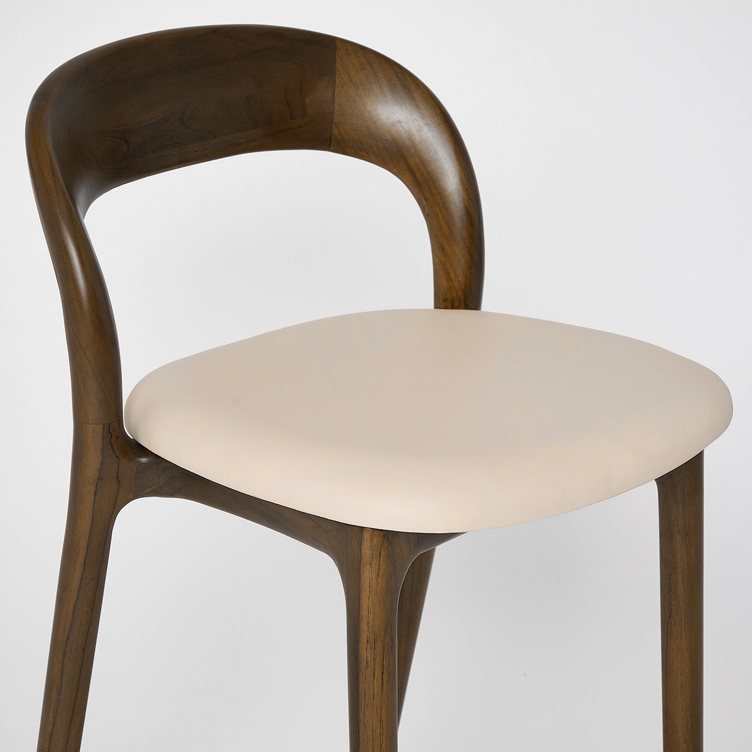 Close-up of the Teak finish on the Interlude Home Felix Classic Walnut Bar Stool Set of 2