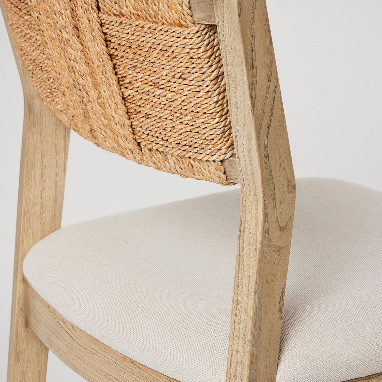Close-up of the oak finish on the Interlude Home Colony Washed Taupe Counter Stool
