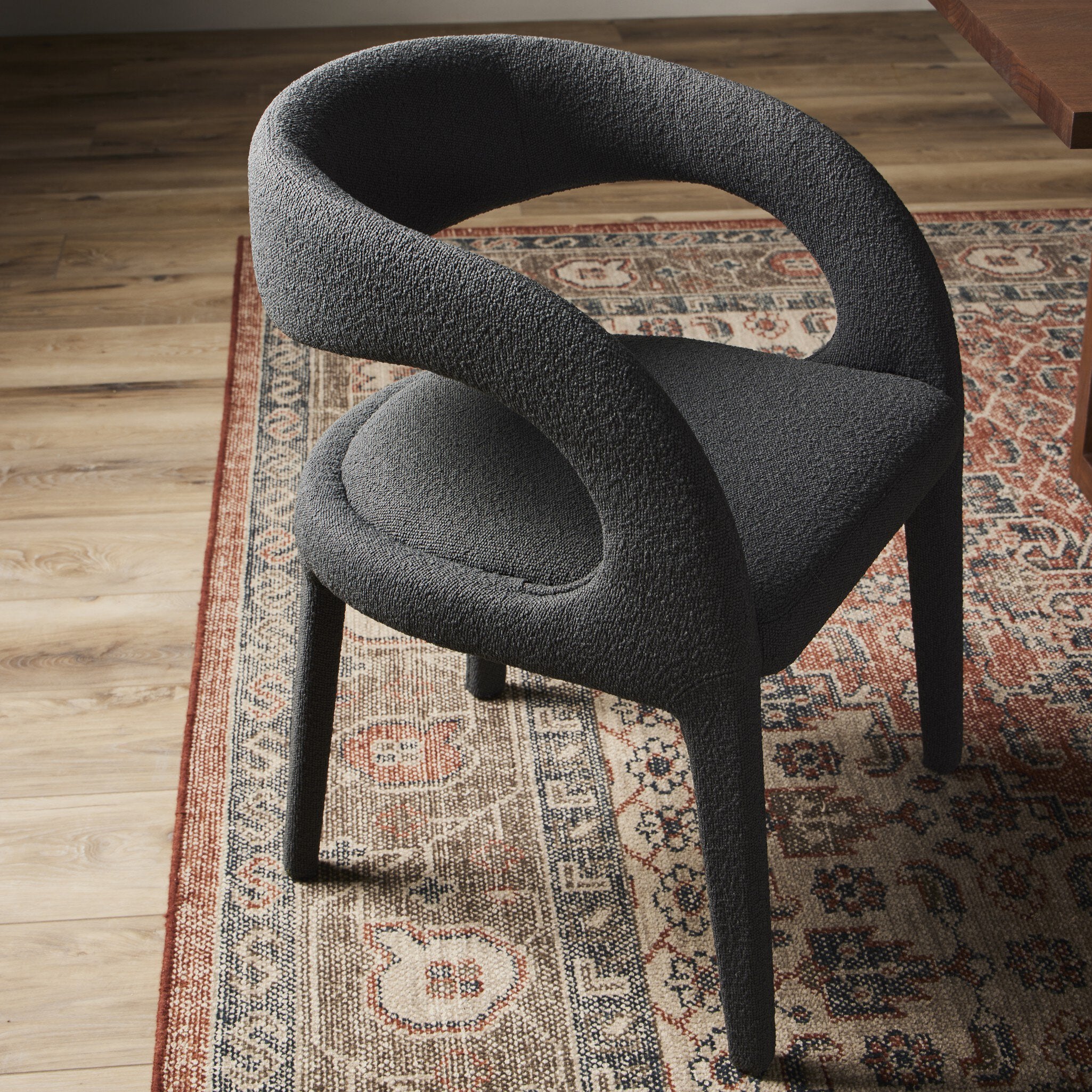 Four Hands Hawkins FIQA Boucle Charcoal Dining Chair shown in a styled interior