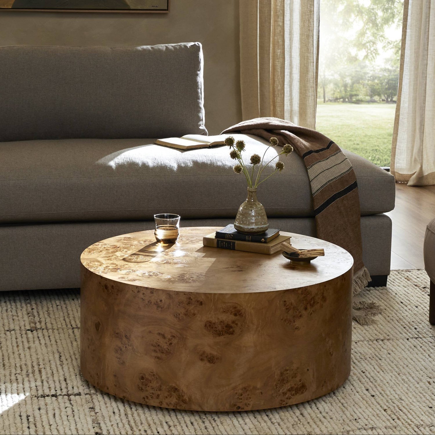Four Hands Caya Caramel Burl Coffee Table styled in a room setting