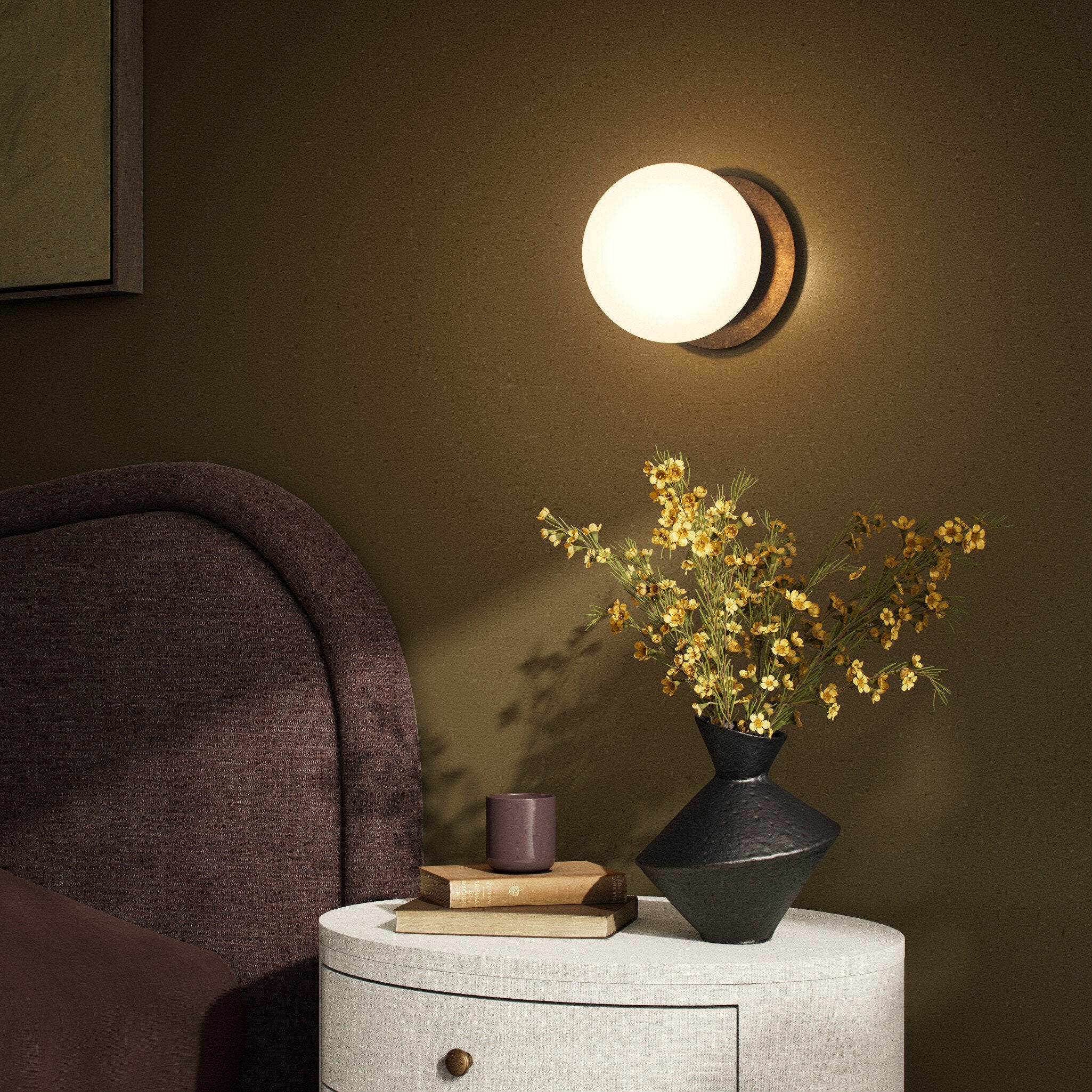 Four Hands Pulsar Heritage Bronze Brass Wall Sconce styled in a room setting