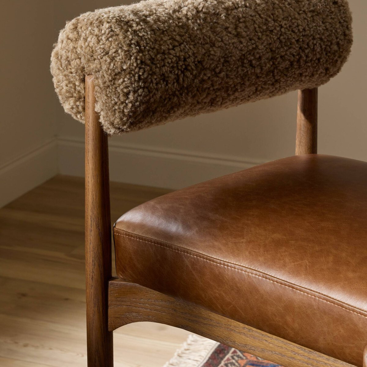 Four Hands Jazelle Havana Brown Bar Stool with leather and shearling, close-up detail of shearling seat, view 2