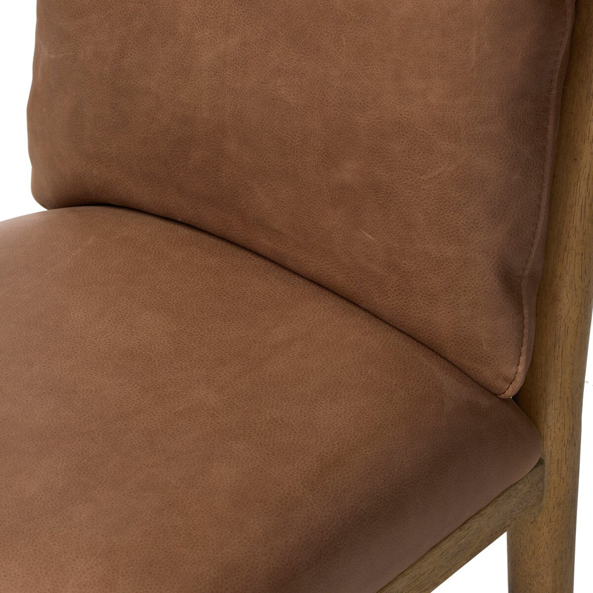 Four Hands Gallagher Palermo Cigar Dining Chair in top-grain leather on drifted parawood, close-up detail of leather, view 4