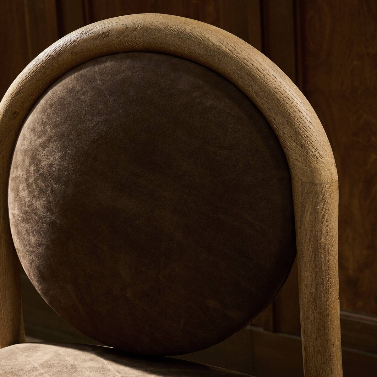 Four Hands Prentiss Dining Chair in nubuck cigar leather, close-up detail of leather and oak frame, view 1