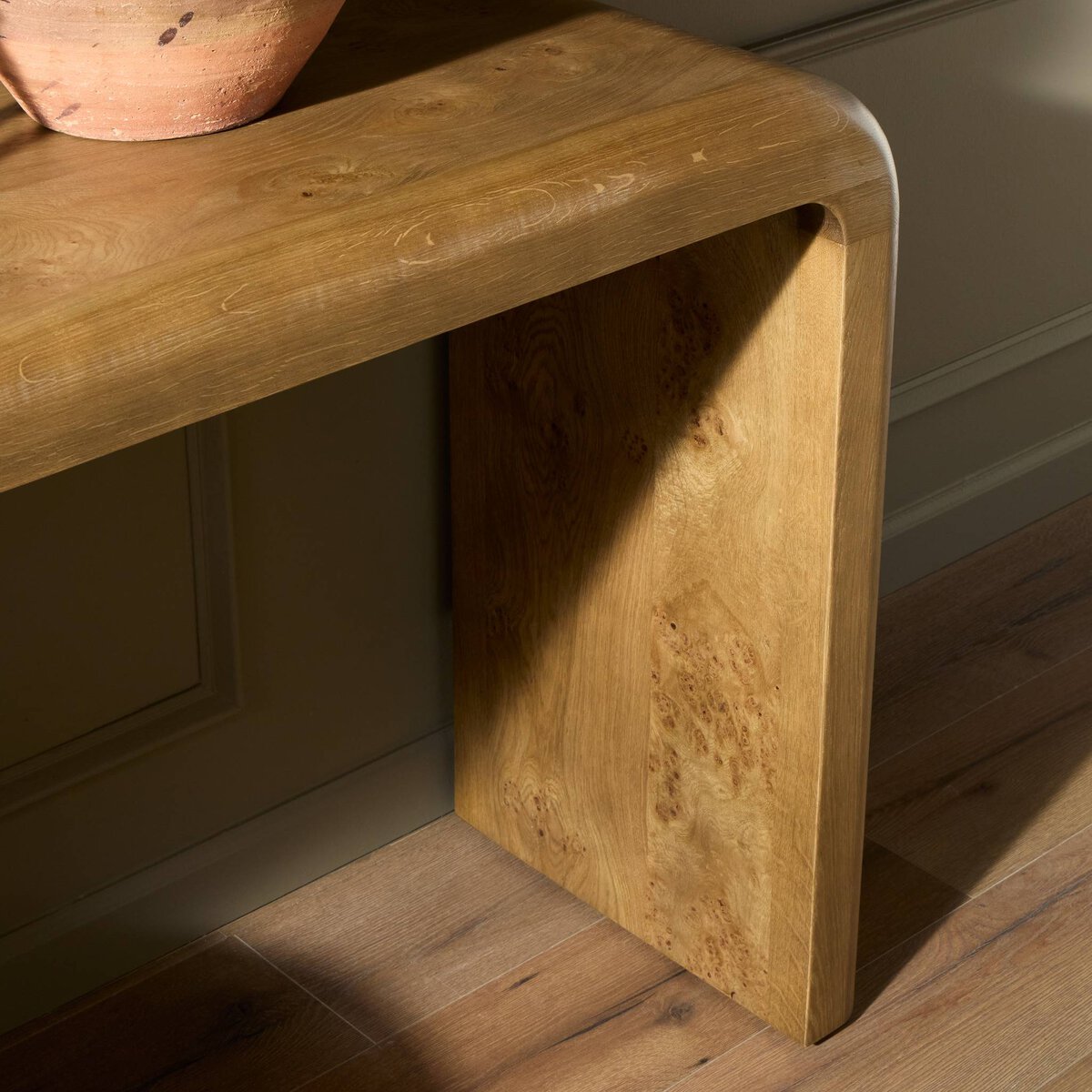 Four Hands Daven Console Table in rye burl oak with waterfall shape, close-up detail of burl grain, view 1