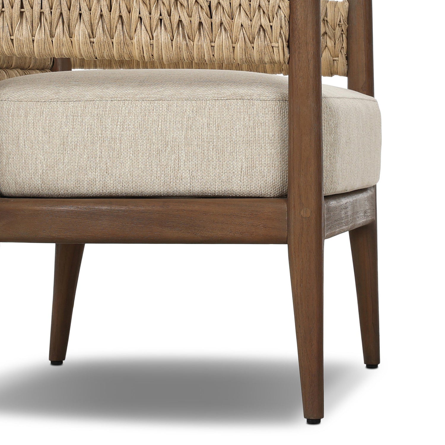 Four Hands Atwood Outdoor Chair in teak with coastal weave and beige cushion, close-up detail, view 2