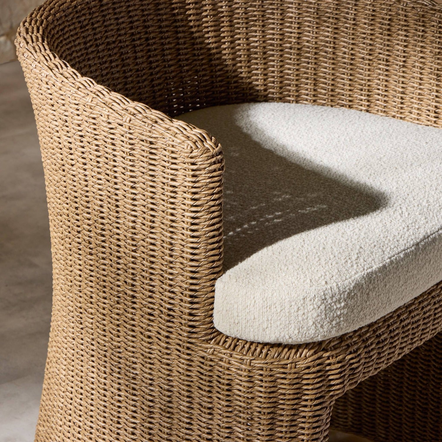 Four Hands Thora Vada Cream Outdoor Dining Chair in faux dark hyacinth with boucle cushion, alternate styled view, view 2