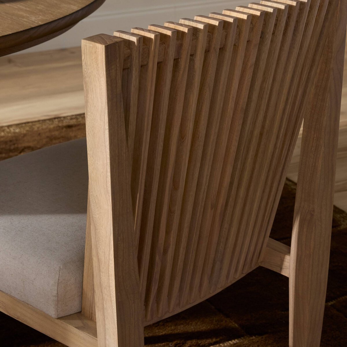 Four Hands Cavallo Dining Chair Set of 2 in sand linen with slatted sungkai back, close-up detail of slatted back, view 1