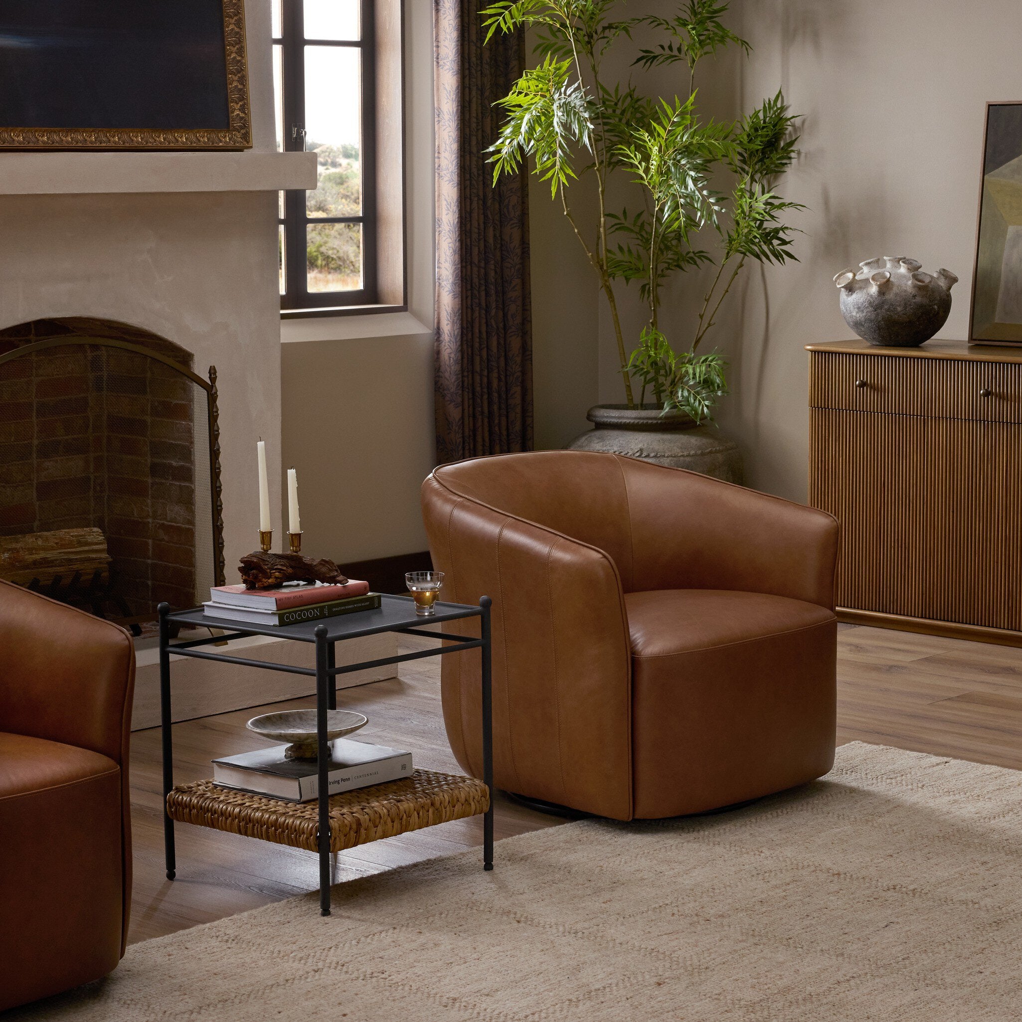 Four Hands Rodgers Sonoma Chestnut Swivel Chair in a styled room setting