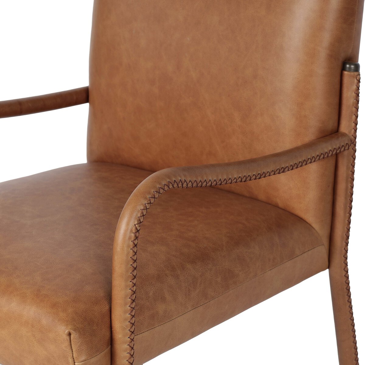 Four Hands Quill Dining Armchair in Chaps Saddle leather with leather-wrapped iron legs, close-up detail of leather, view 4