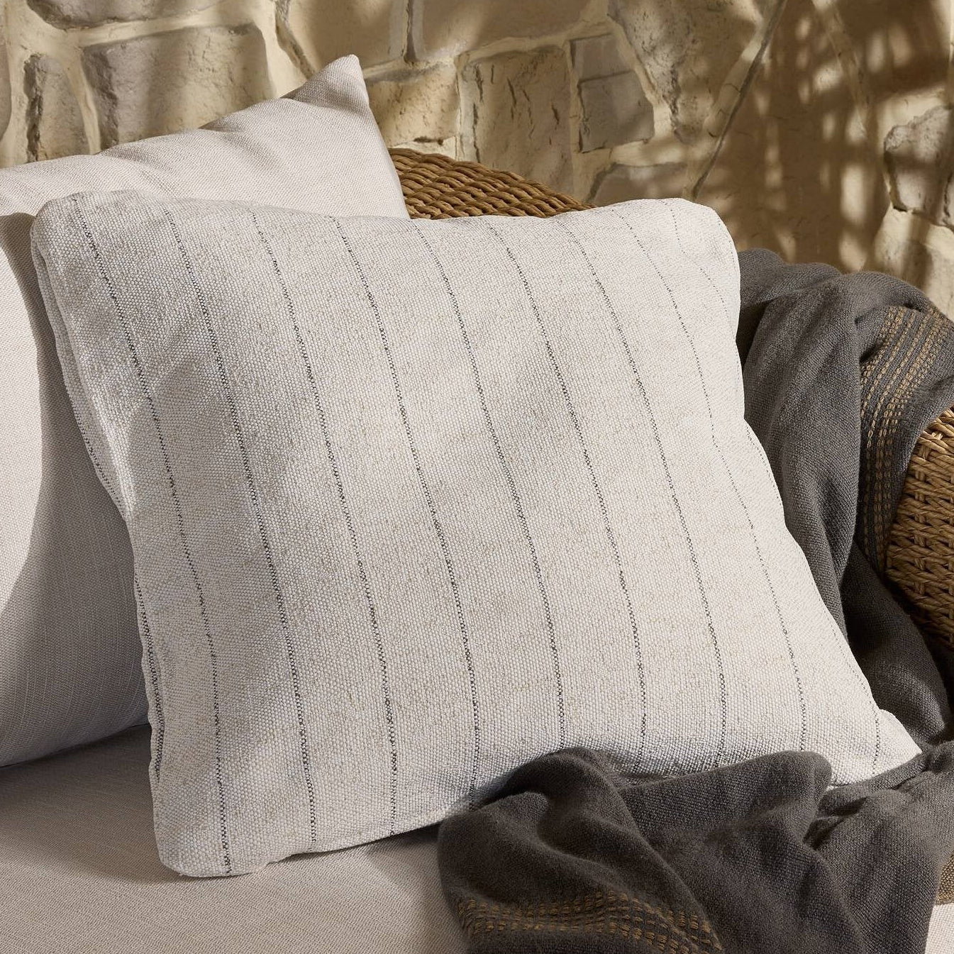 Four Hands Aldama Amalfi Natural Outdoor Throw Pillow styled in a room setting