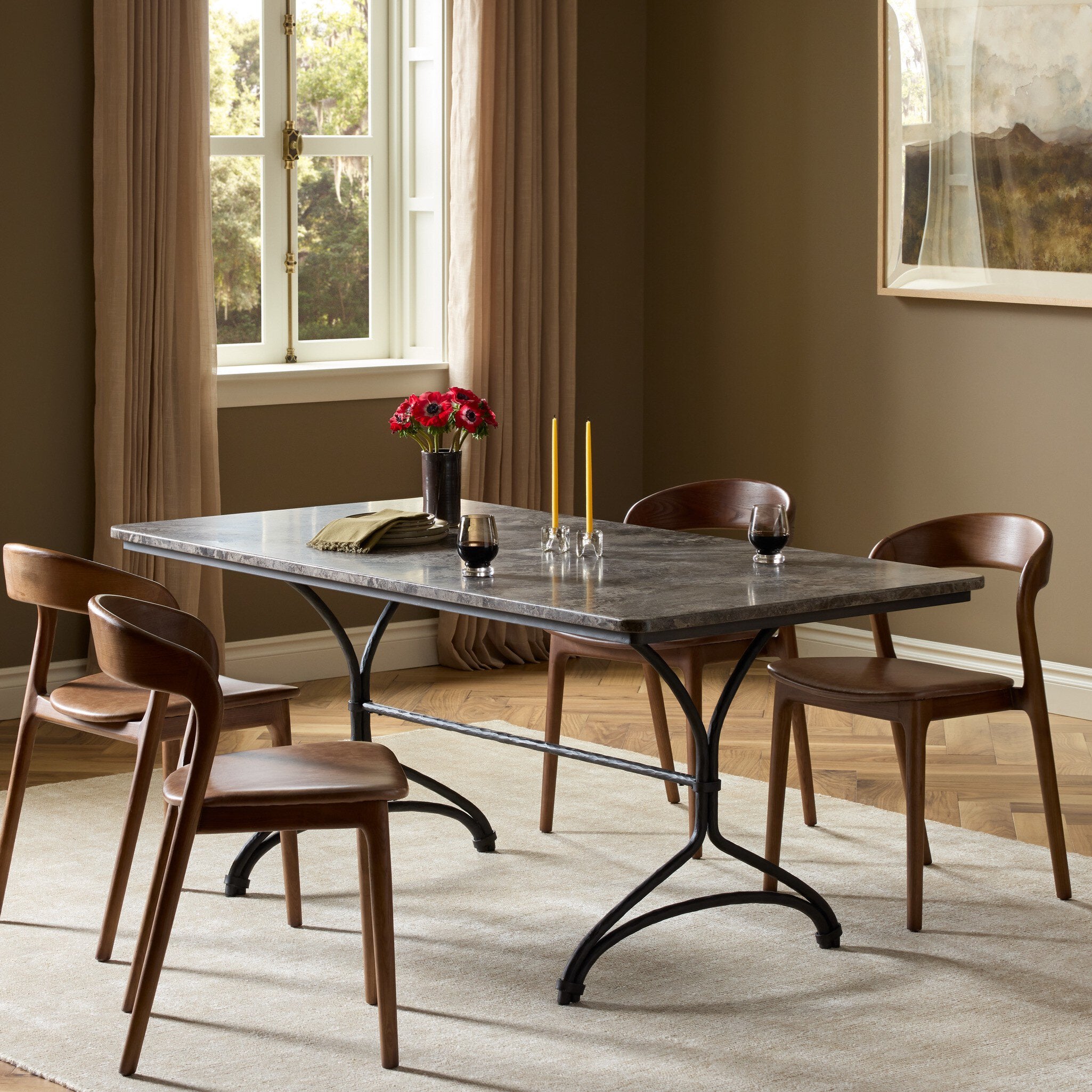 Four Hands Nyssa Warm Grey Marble Dining Table in a styled room setting