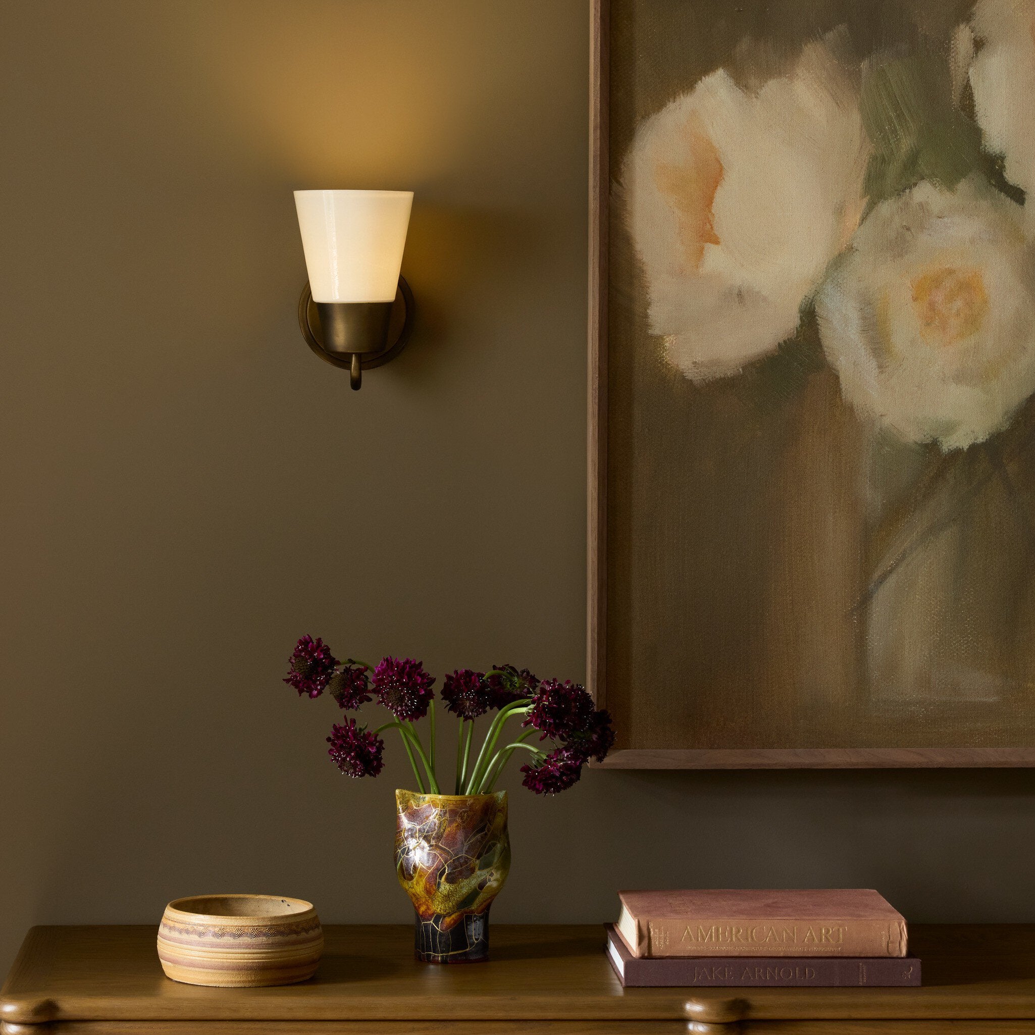 Four Hands Mavis Milk Glass Wall Sconce styled in a room setting