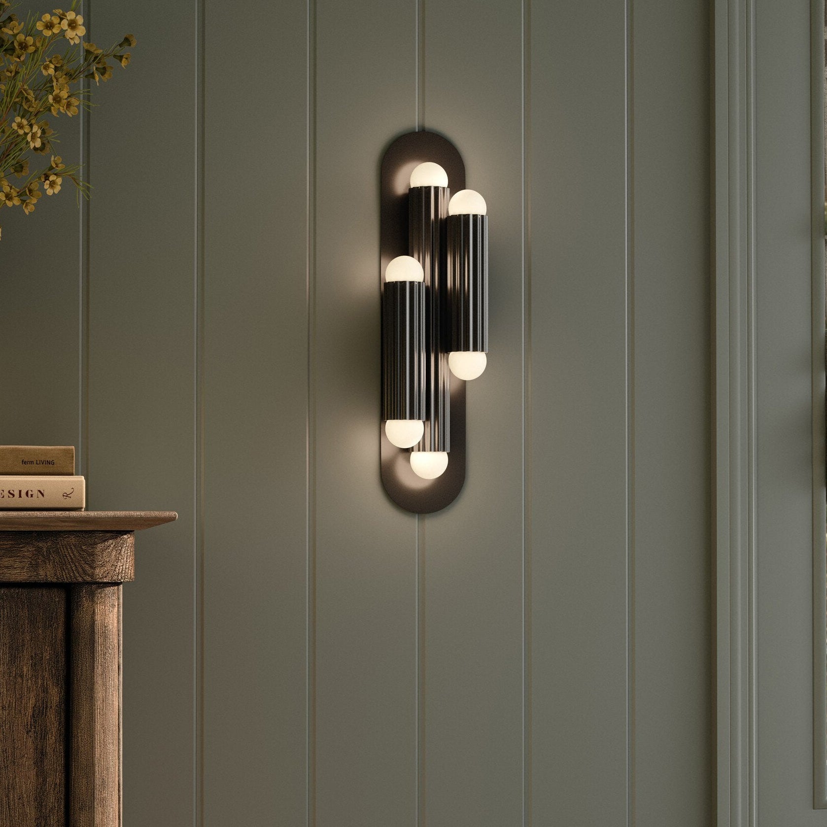 Four Hands Vesta Black Gunmetal Triple Wall Sconce styled in a room setting
