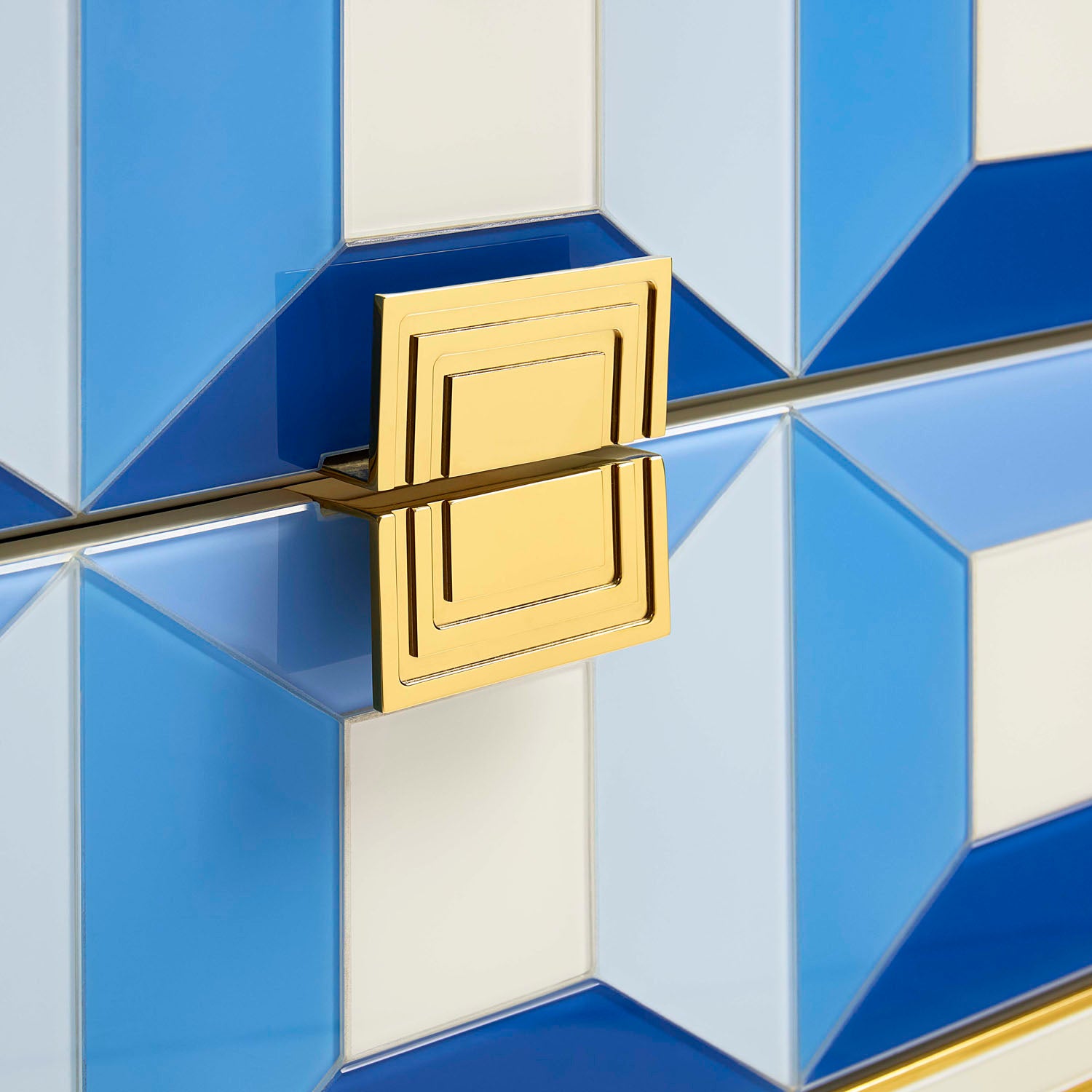 Jonathan Adler The Sorrento two-drawer console in blue back-painted glass with brass against a neutral backdrop