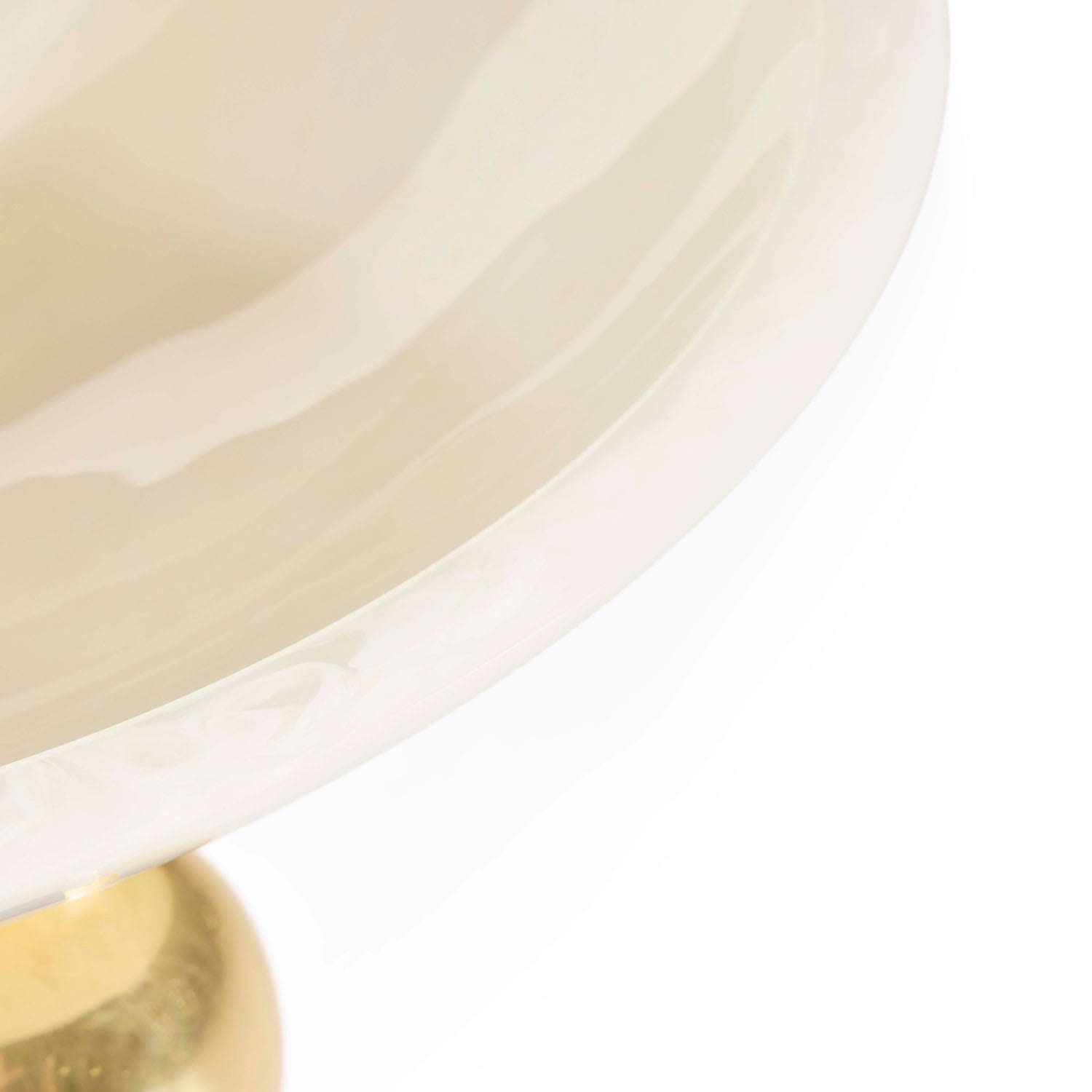 Jonathan Adler Fontana Bowl in white marbleized acrylic with brass feet styled in a room