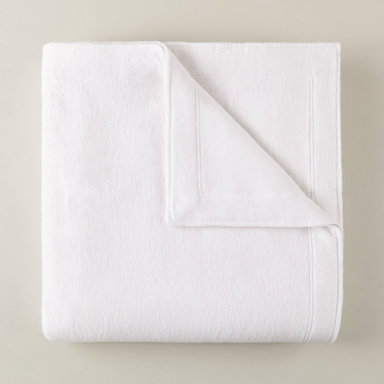 Peacock Alley All Seasons framed brushed cotton throw blanket styled in a bright bedroom