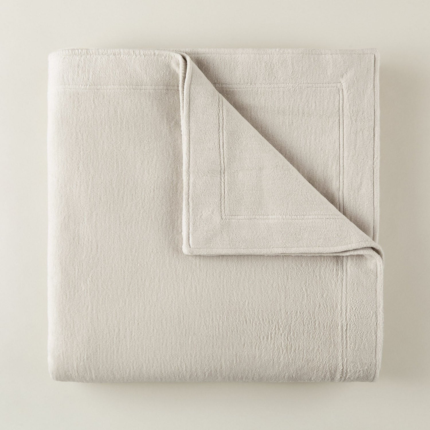 Peacock Alley All Seasons framed brushed cotton throw blanket shown in a lighter colorway