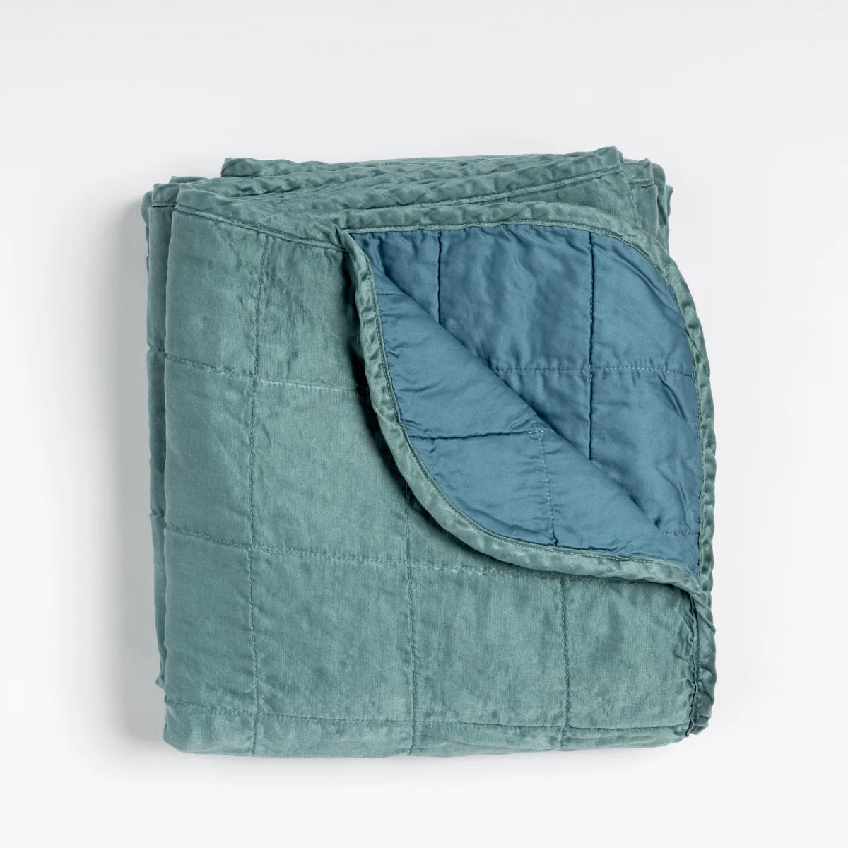 Bella Notte Sel Throw Blanket in quilted charmeuse, styled against a linen backdrop