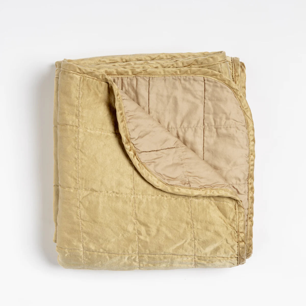 Bella Notte Sel Throw Blanket in quilted charmeuse, styled by a sunlit window
