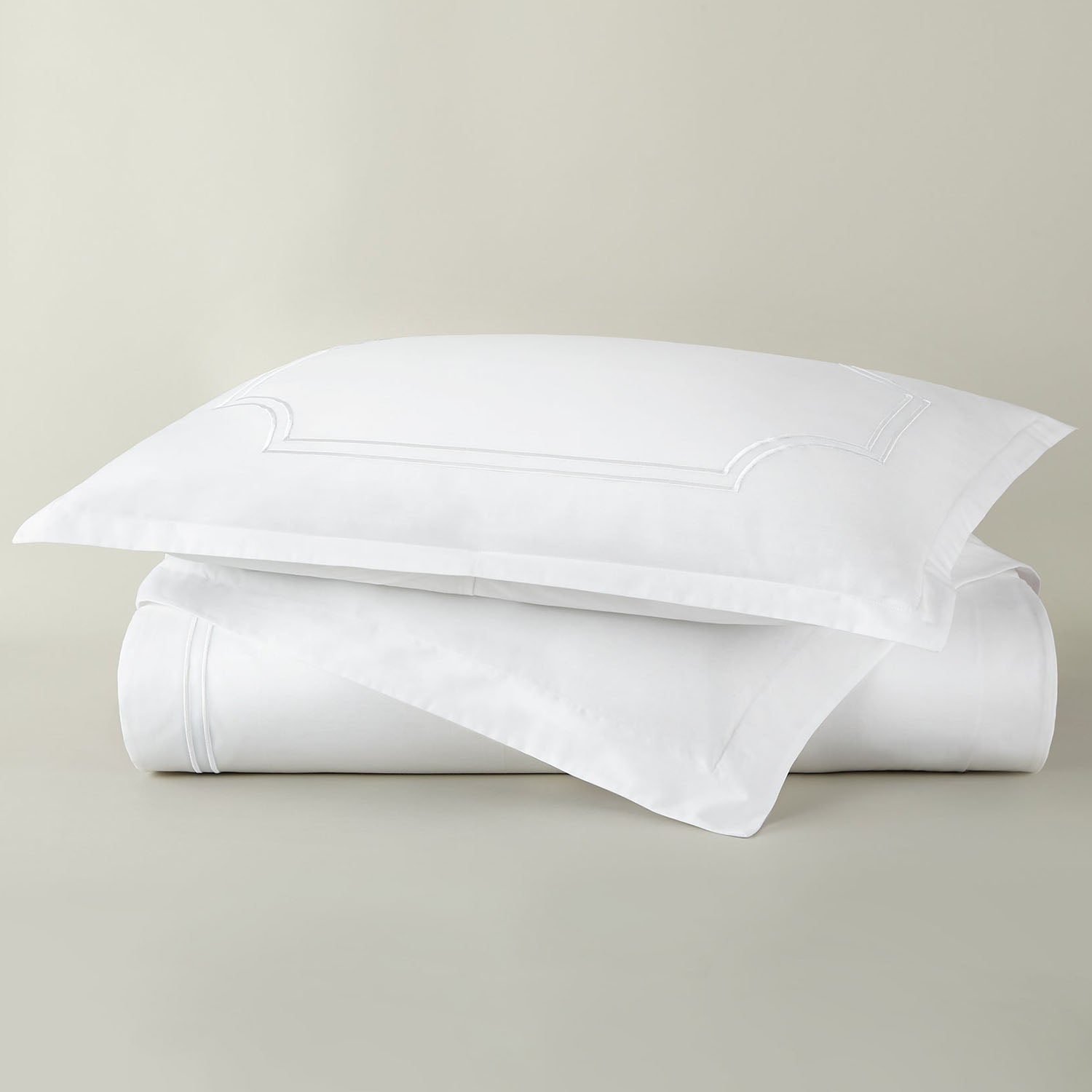 Peacock Alley Deco embroidered cotton percale duvet set stack of neatly folded linens