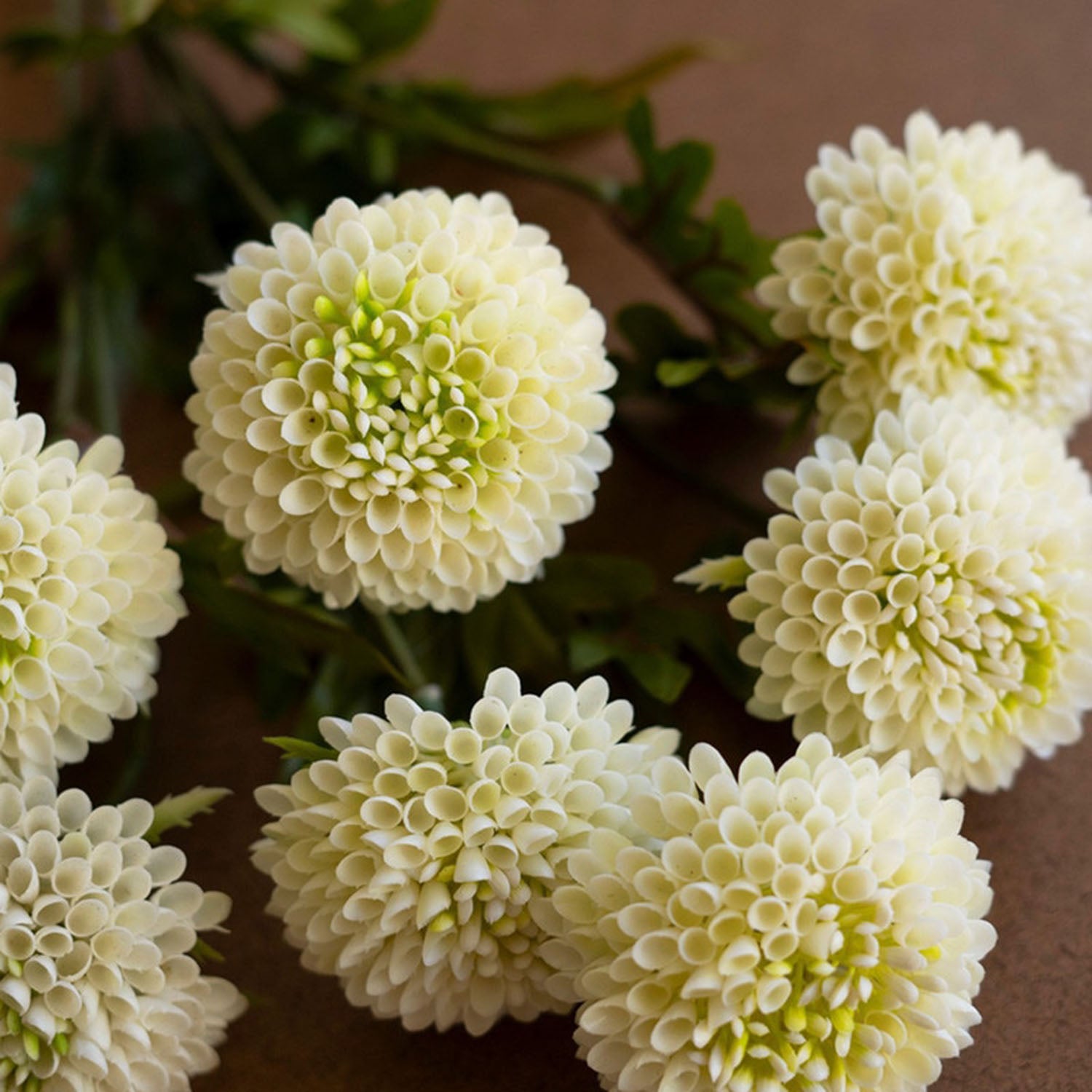 Blush faux dahlia bloom shown from a three-quarter angle