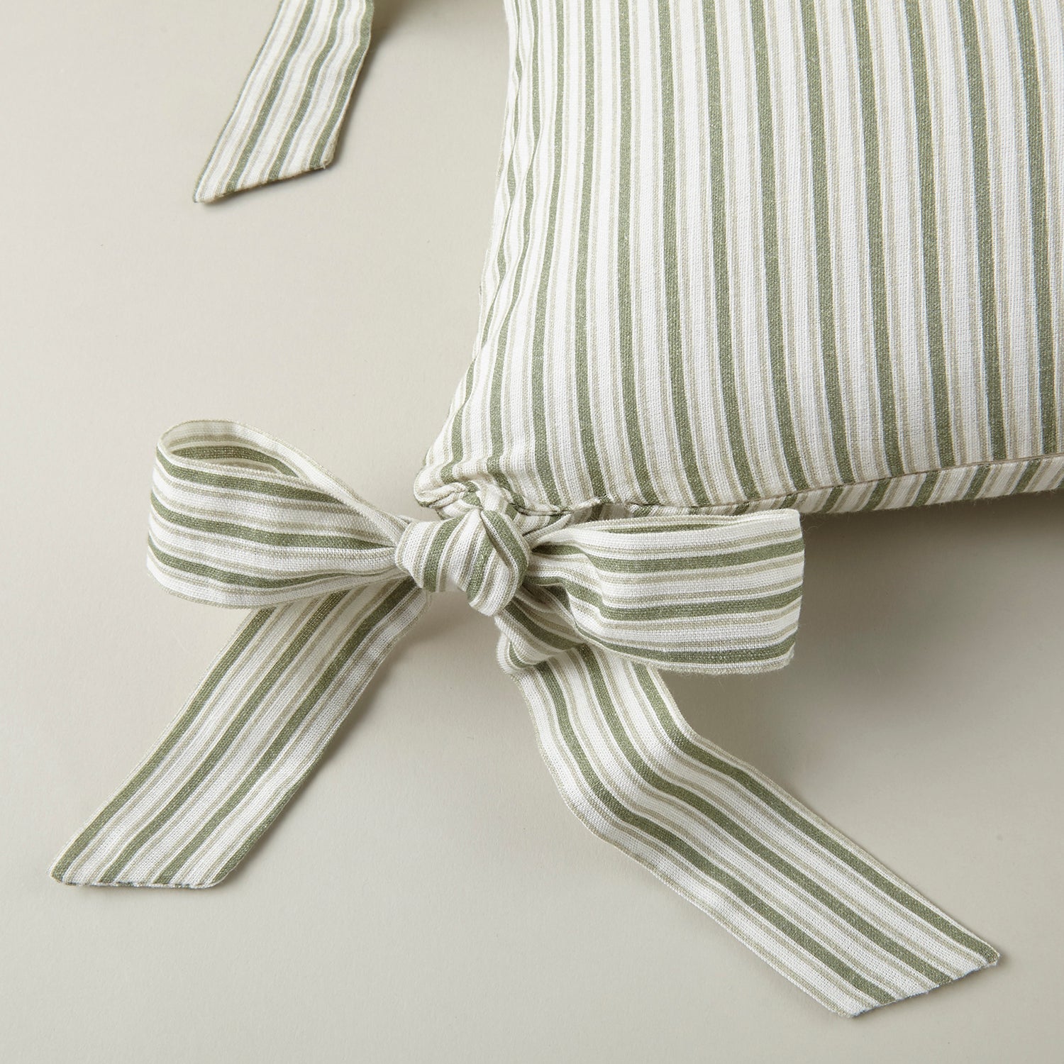 Caitlin Oblong Bow Pillow cotton flame accent pillow, shown in a lighter colorway