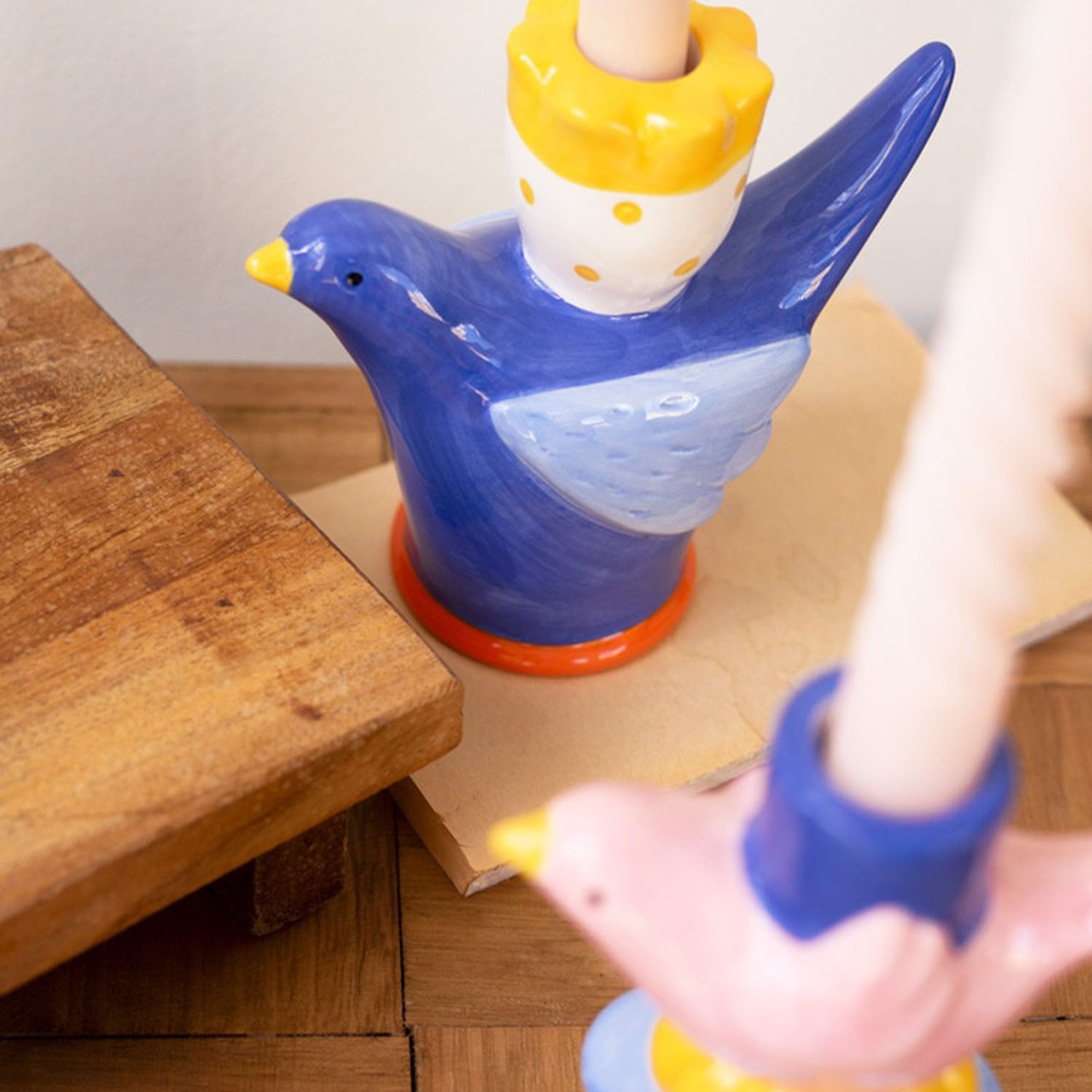 Close-up of a painted ceramic bird taper candle holder