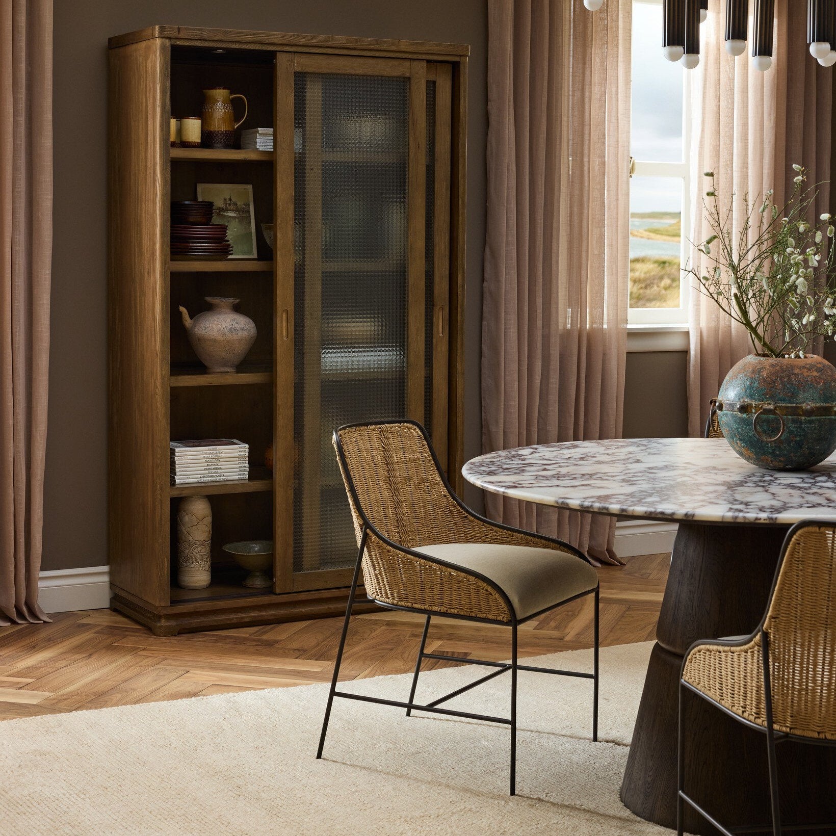Four Hands Lino Calacatta Viola Marble Dining Table shown in a decorated space