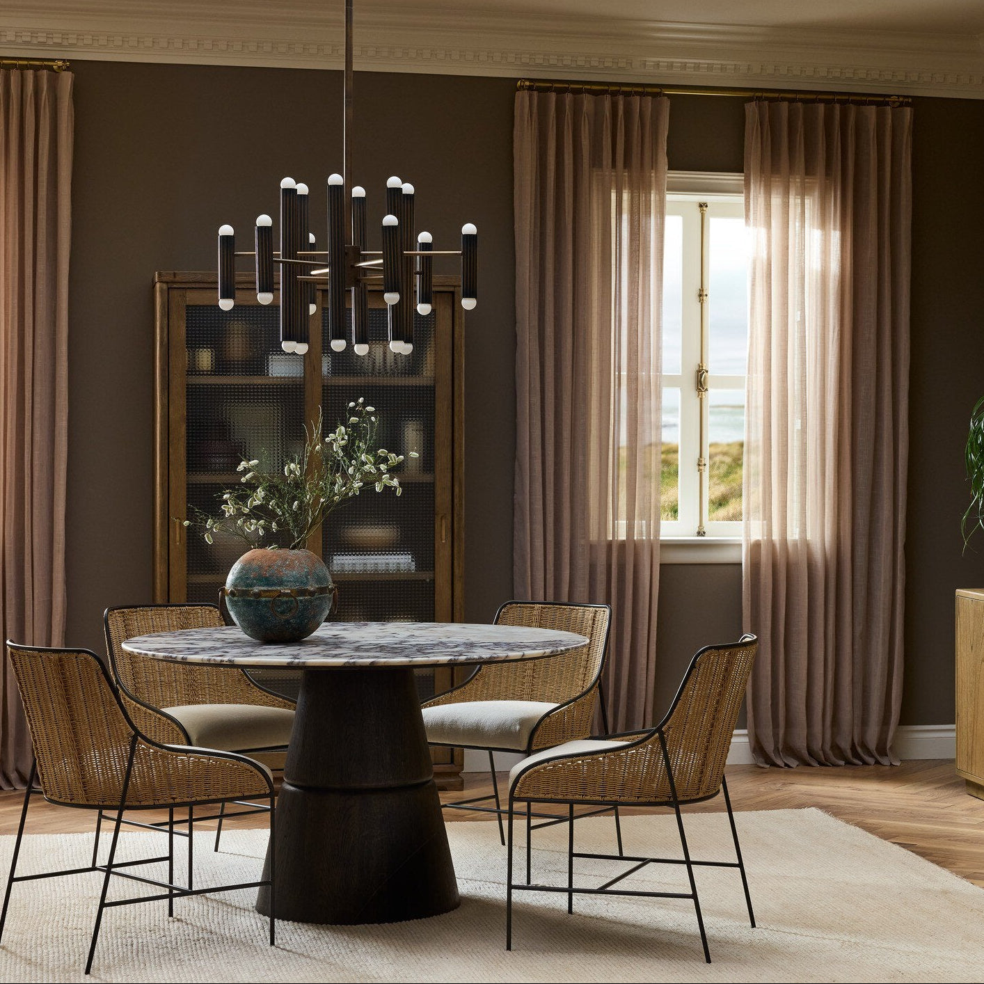 Four Hands Lino Calacatta Viola Marble Dining Table shown in a decorated space (2)