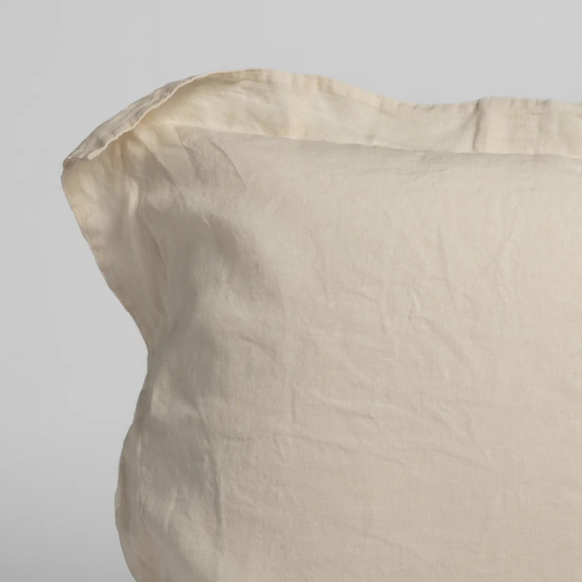 Bella Notte Linen Pillow Sham in linen, draped over the arm of a bench (view 39)