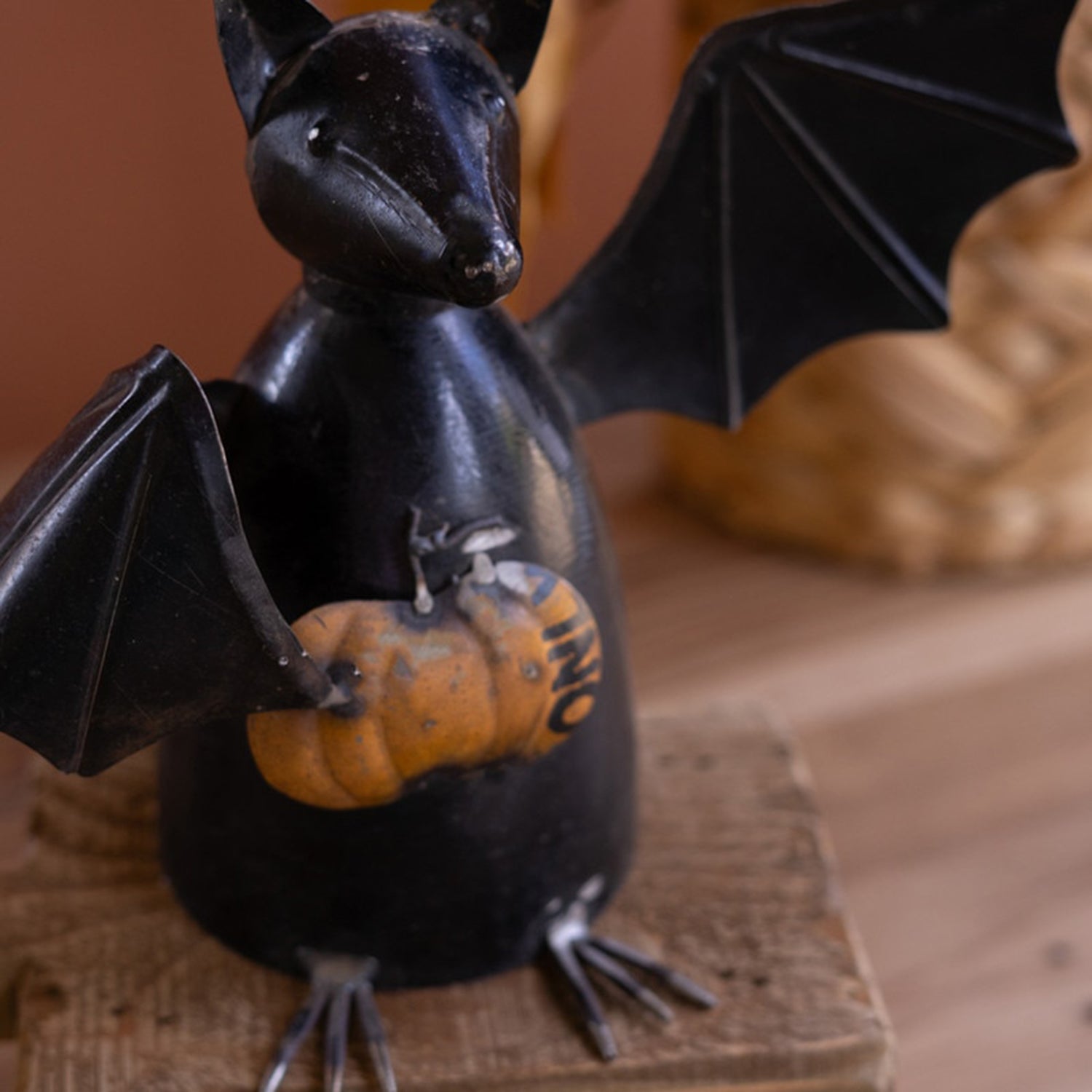 Recycled Metal Bat Holding a Pumpkin