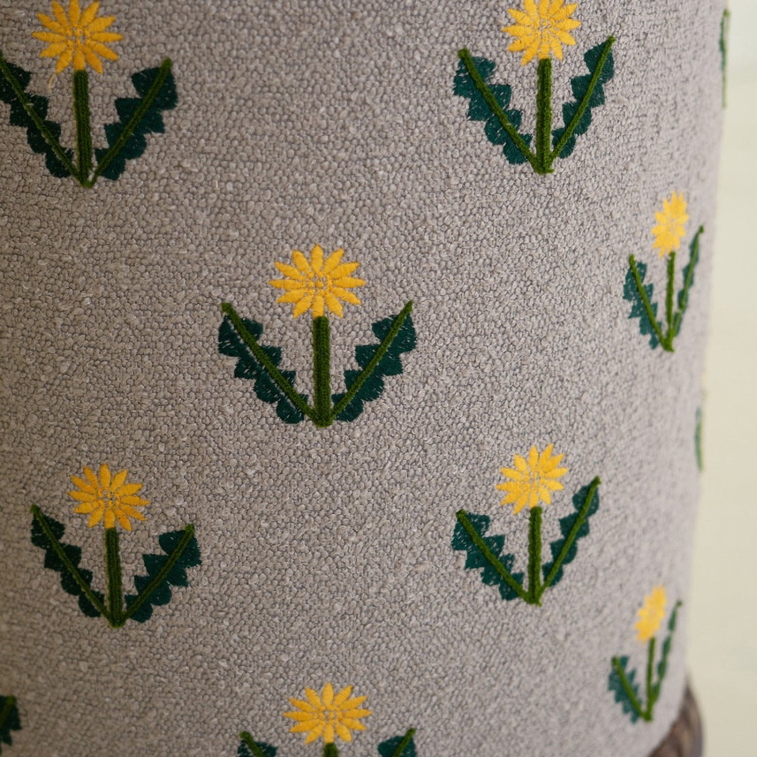 Upholstered Gray Ottoman with Embroidered Detail