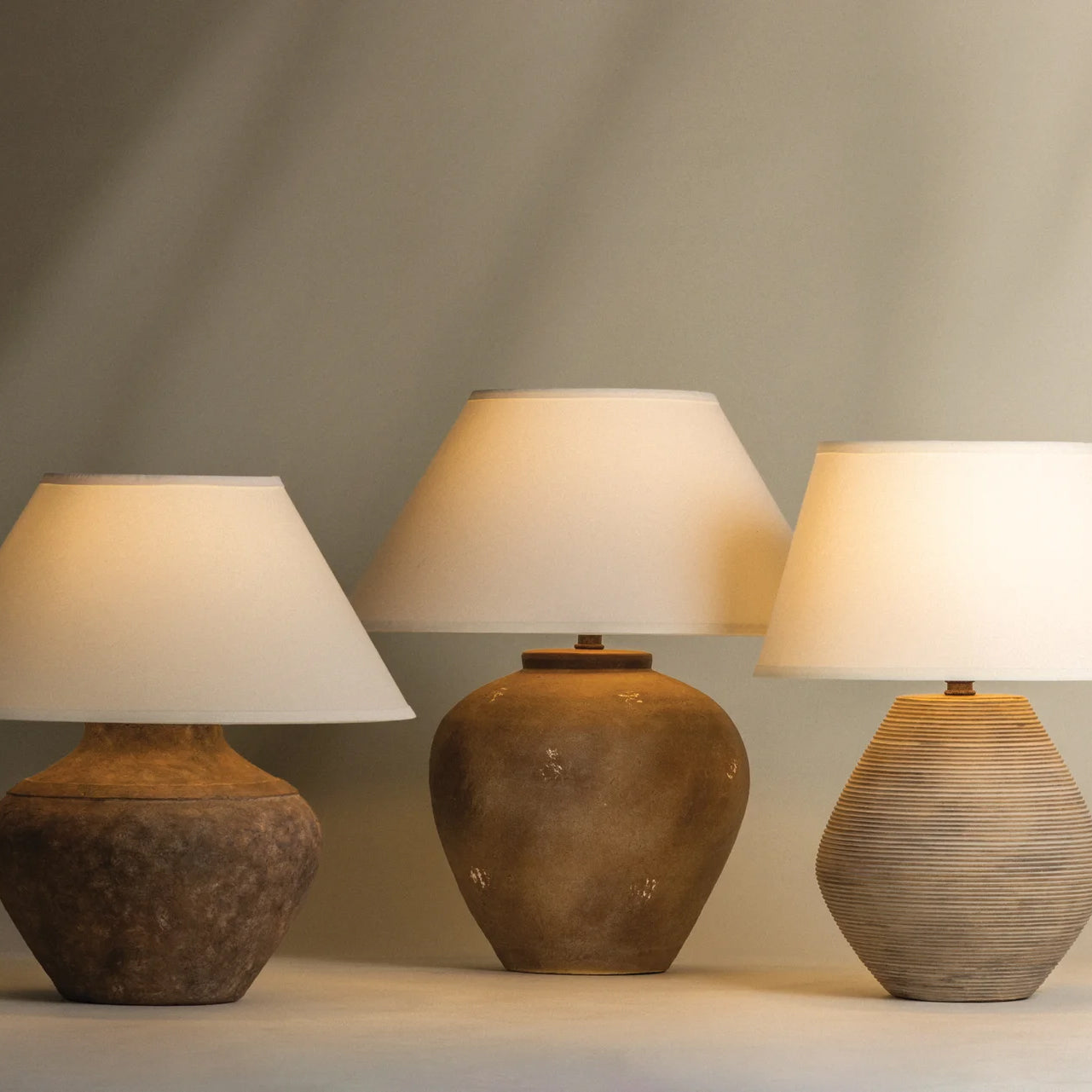 Troy Lighting Calabria 23-inch Table Lamp in sienna, shown lit against a dark background