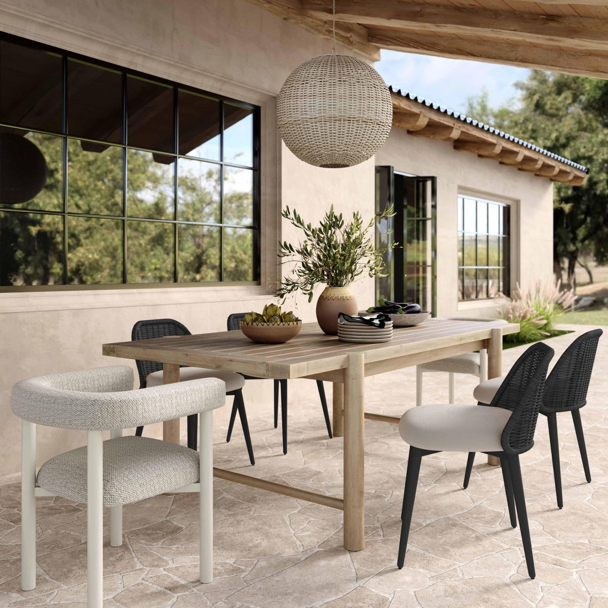 Alexa black rattan performance dining chair, three-quarter angle view