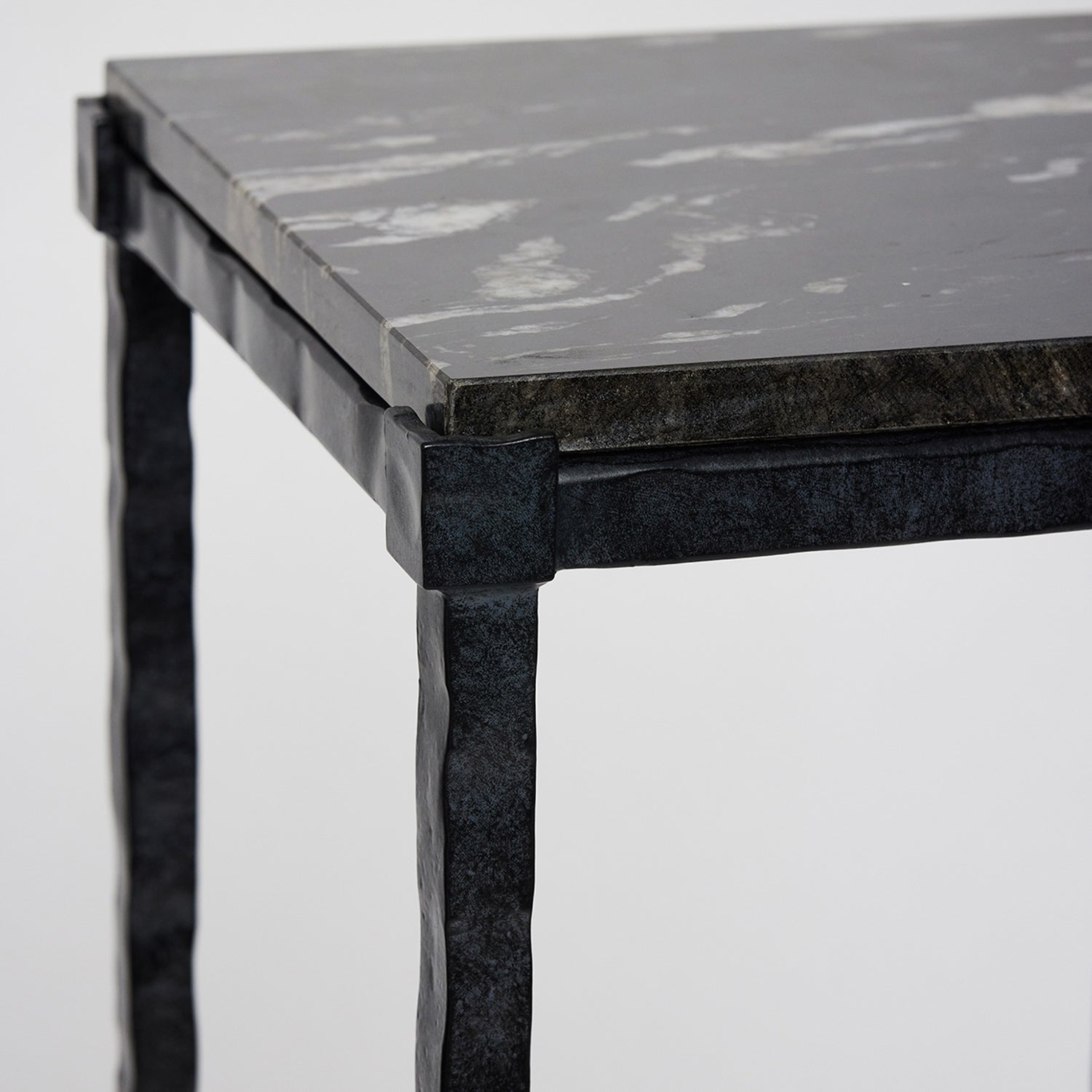 Detail of the marble top on the Interlude Home Reese Hammered Charcoal Grand Pedestal