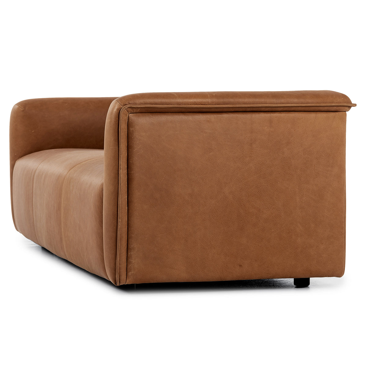 Three-quarter view of a tan leather sofa.