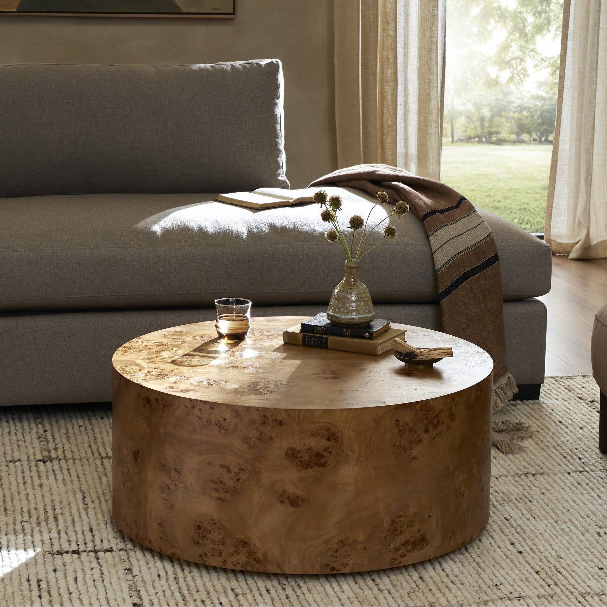 Four Hands Caya Caramel Burl Coffee Table styled in a room setting