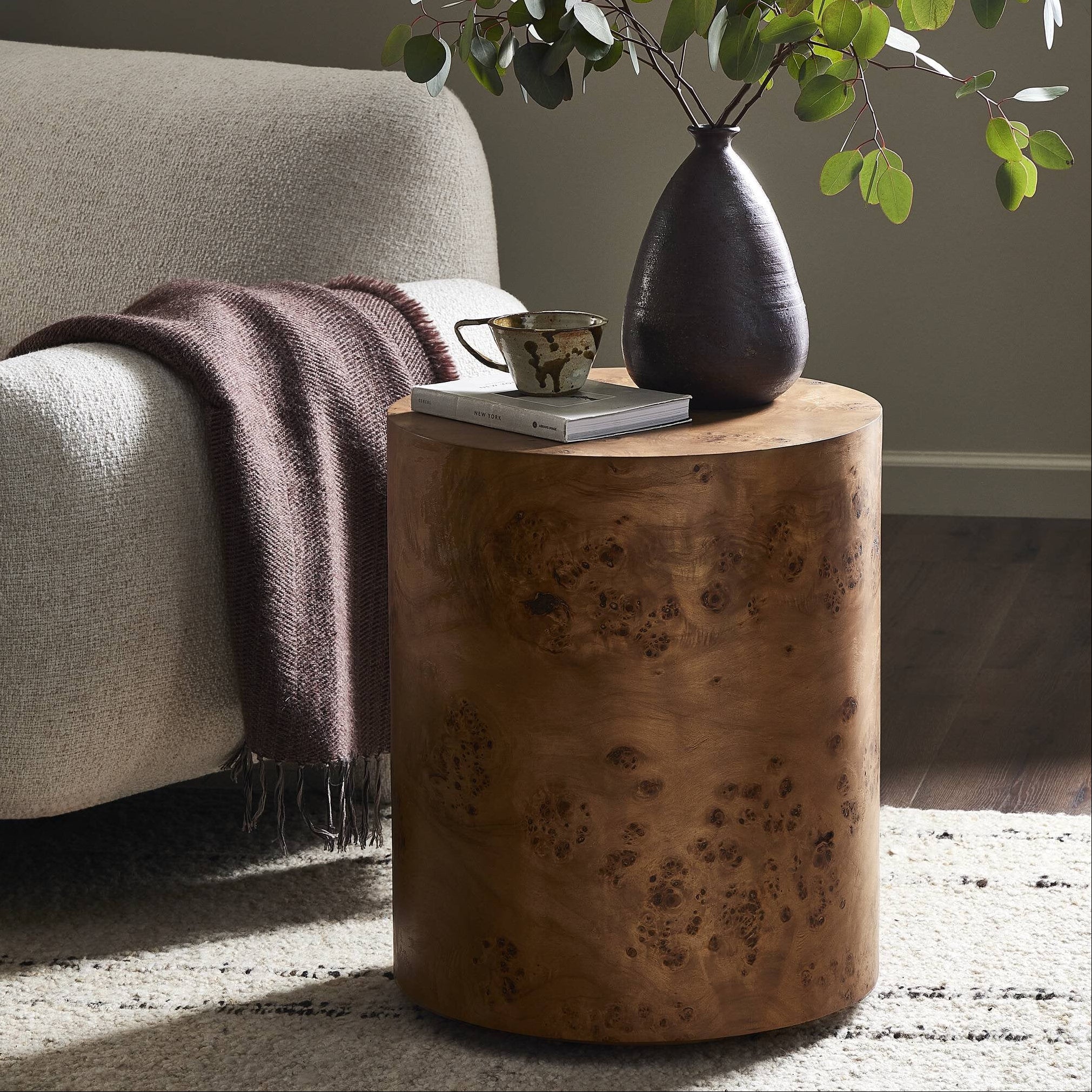 Four Hands Caya Caramel Burl End Table styled in a room setting