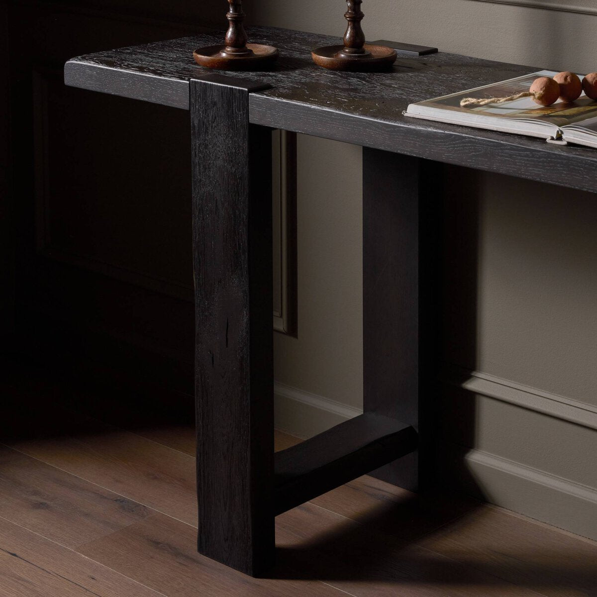 Four Hands Matei Console Table in smoked black solid oak with through-tenon joints, close-up detail of oak grain, view 1