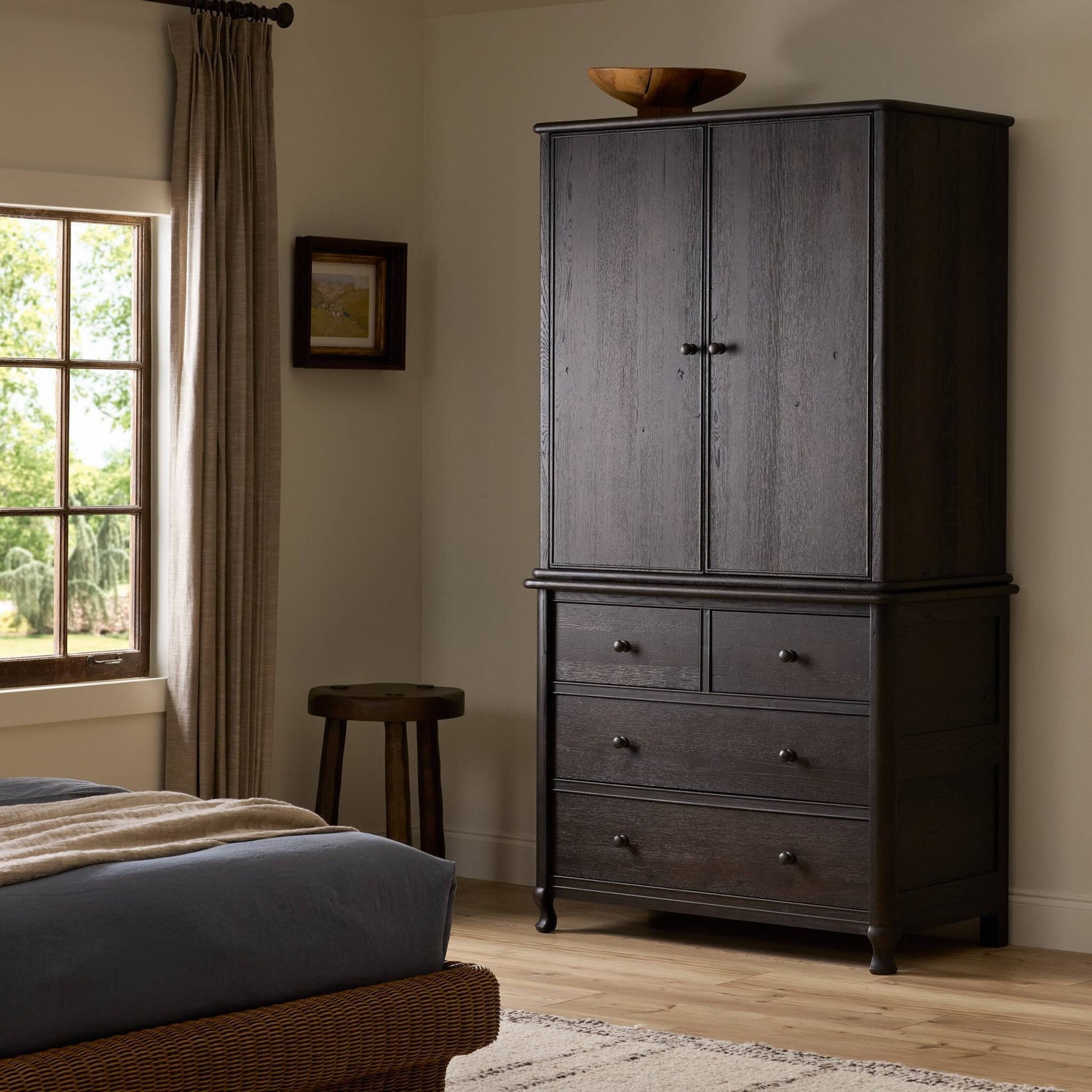Four Hands Pika Smoked Black Oak Armoire styled room setting