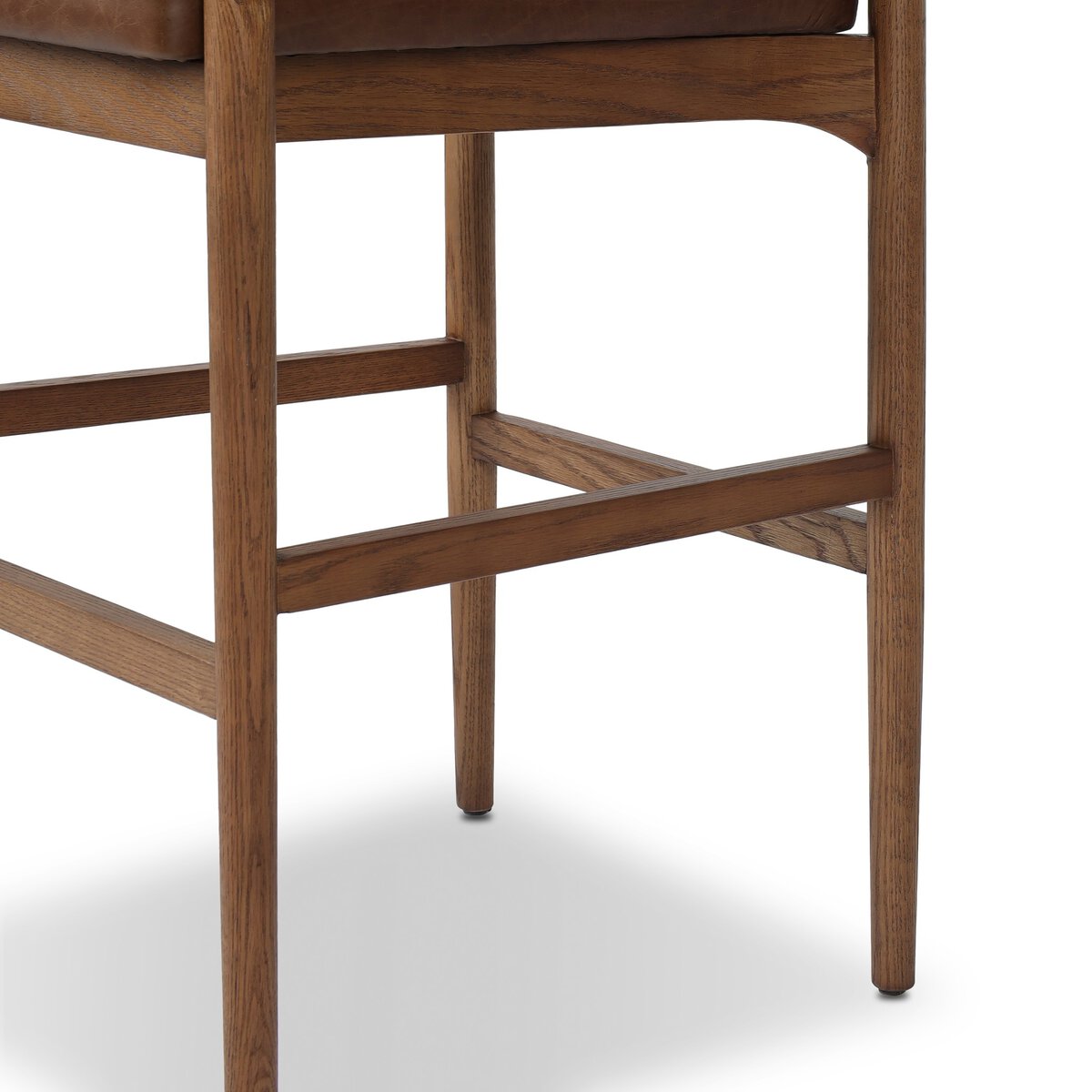 Four Hands Jazelle Havana Brown Bar Stool with leather and shearling, close-up detail of ash leg