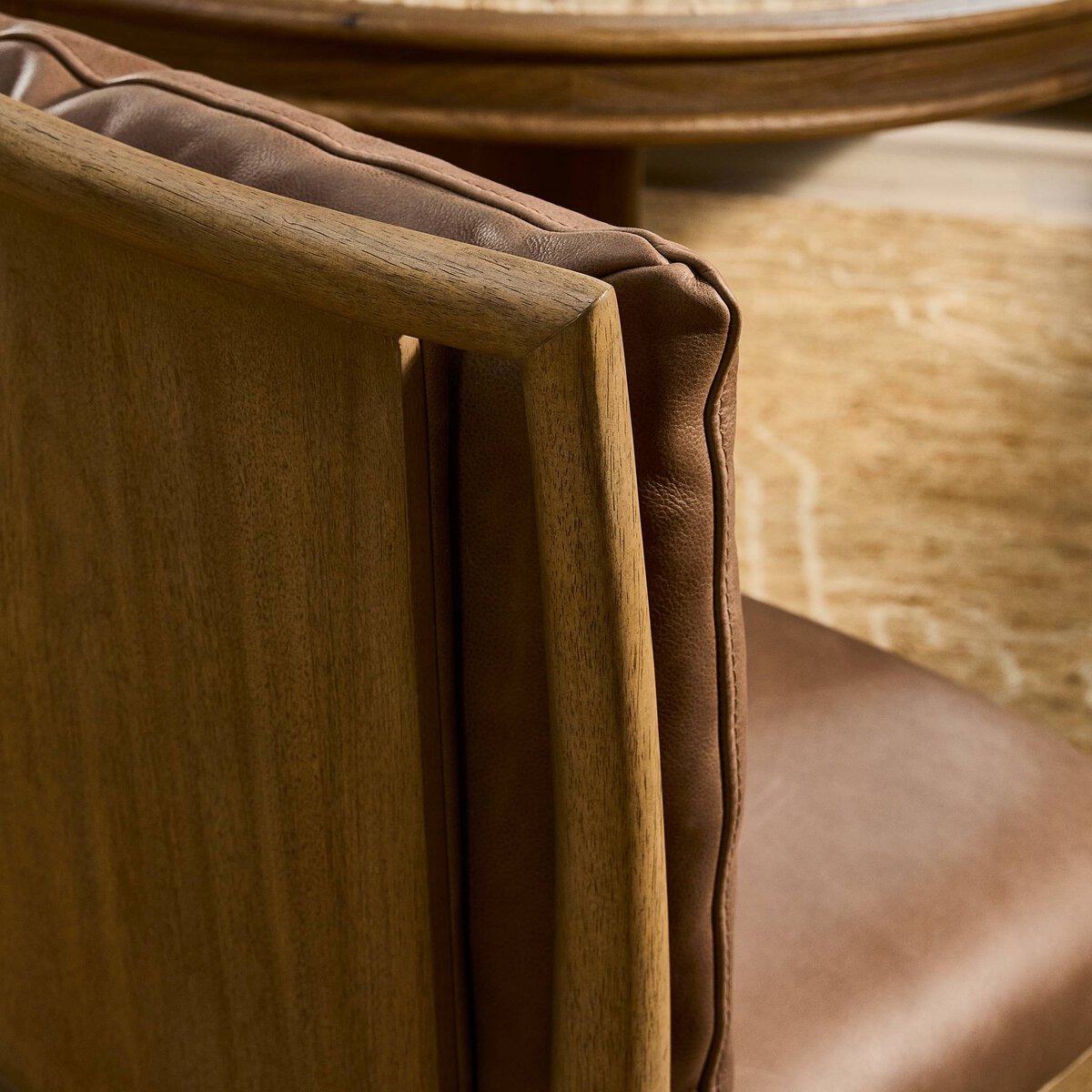 Four Hands Gallagher Palermo Cigar Dining Chair in top-grain leather on drifted parawood, close-up detail of leather, view 2