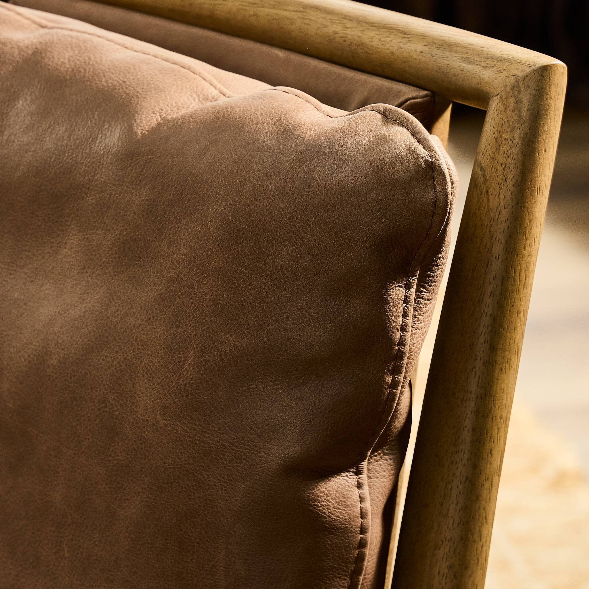 Four Hands Gallagher Palermo Cigar Dining Chair in top-grain leather on drifted parawood, close-up detail of leather, view 1