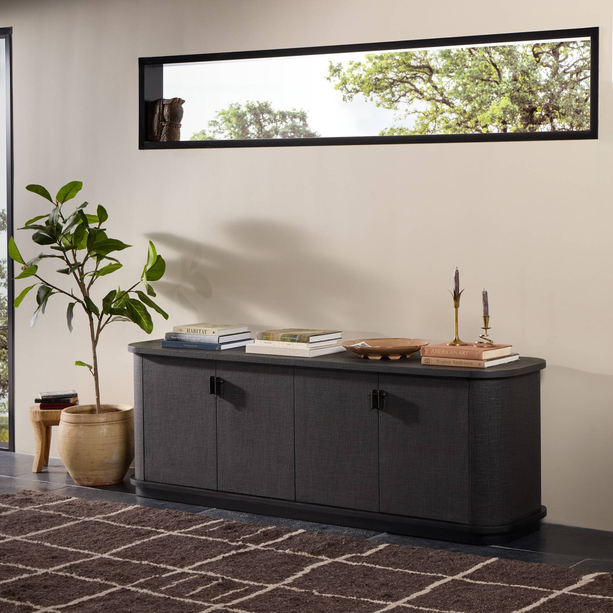 Four Hands Berlin Black Linen Media Console styled in a room setting