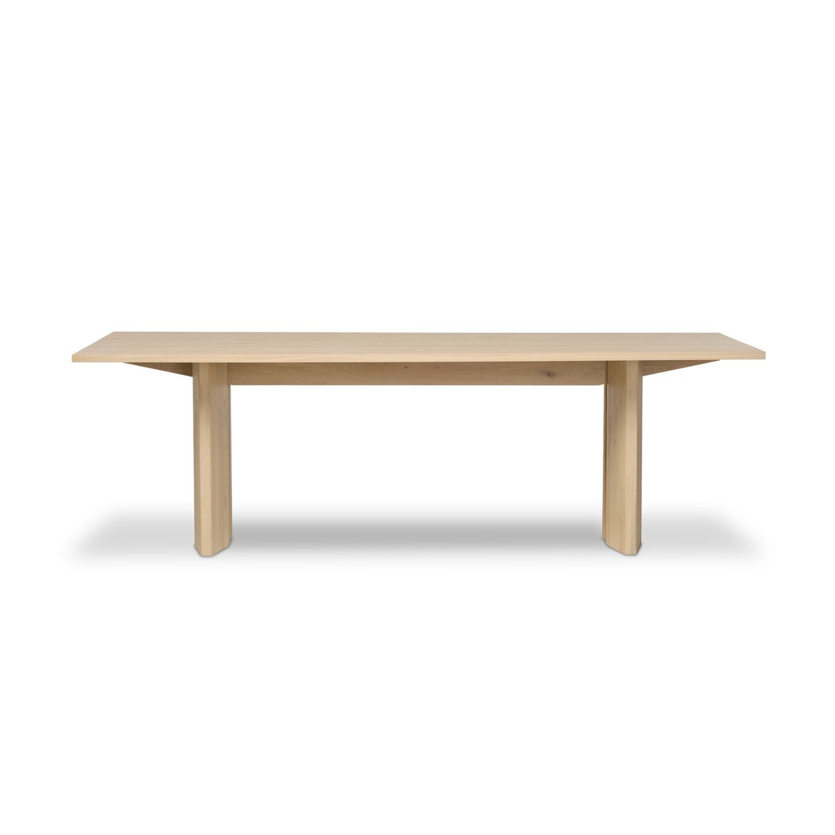 Four Hands Emerald Dining Table in bleached Romanian oak with splice leg detail, back view