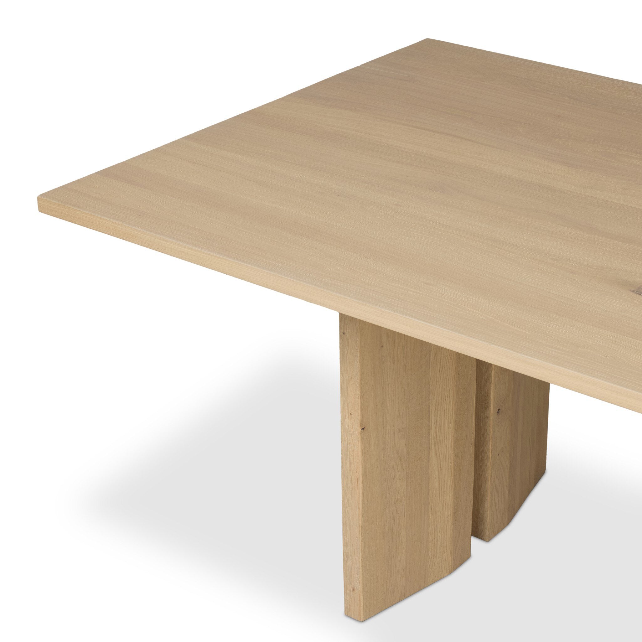 Four Hands Emerald Dining Table in bleached Romanian oak with splice leg detail, close-up detail of oak grain, view 1
