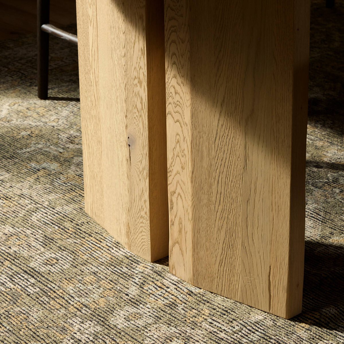 Four Hands Emerald Dining Table in bleached Romanian oak with splice leg detail, close-up detail of splice leg, view 1