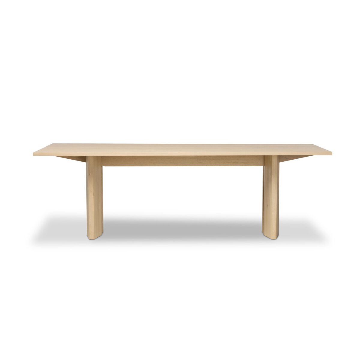 Four Hands Emerald Dining Table in bleached Romanian oak with splice leg detail, front view